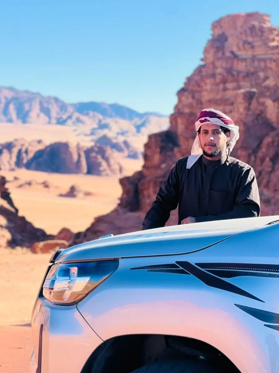 Bashar beside a jeep in the Wadi Rum desert